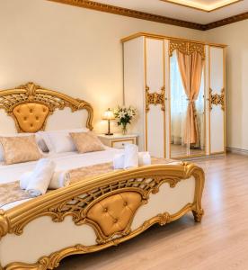 a bedroom with a large bed with a large mirror at Pensiunea Cardinal in Sibiu