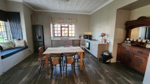 a kitchen with a table and chairs in a room at FinchDen House in Bulawayo