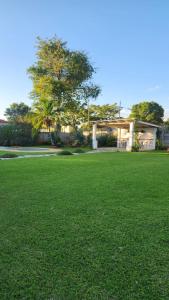 a house with a green lawn in front of it at FinchDen House in Bulawayo