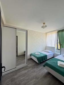 a hotel room with two beds and a mirror at Sunset paradise in Ureki +37 photos