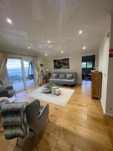 a living room with a couch and a table at Casa Del Mar in Ponta do Sol