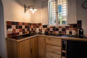 a kitchen with wooden cabinets and a sink and a window at Casa Elisabetta in Tuscania