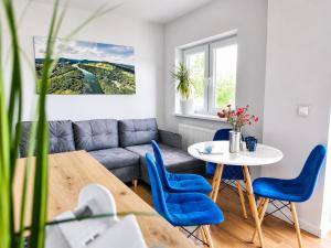 a living room with a couch and a table and chairs at Willa Panorama 881-751-206 in Polańczyk +73 photos