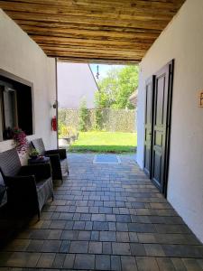 a patio with chairs and an open door at Brick House in Fürstenfeld