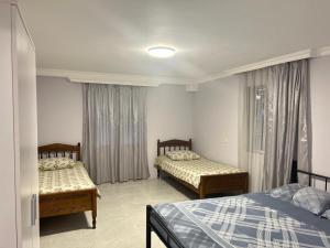 a bedroom with two beds and a window at Welcome to Kobuleti in Kobuleti