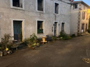 an old building with a picnic table in front of it at Comme à La Maison in Cayres