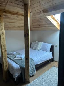 a bedroom with a bed and a wooden ceiling at Къща за гости Гергана in Troyan