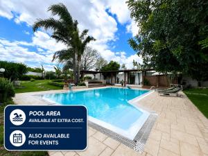 a swimming pool with a sign in front of a house at Independent Apartments in Modugno in Modugno