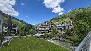 a town in the mountains with a river and buildings at Limone Piemonte Kids Friendly in Limone Piemonte