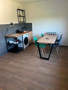 a room with a table and chairs and a kitchen at Hospodářství u kapličky in Kladeruby nad Oslavou