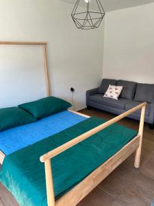 a bedroom with a bed and a couch at Hospodářství u kapličky in Kladeruby nad Oslavou