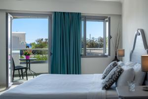 a bedroom with a large bed with a green curtain at Smaragdi in Perivolos