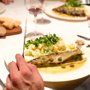 a person is eating a plate of food on a table at Las termas de los Molles in Los Molles
