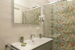a bathroom with a sink and a shower curtain at La Casa al Centro in Policoro