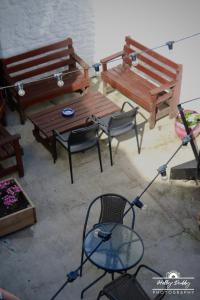 a patio with benches and a table and a chair at The Kings Arms Hotel, Lostwithiel in Lostwithiel