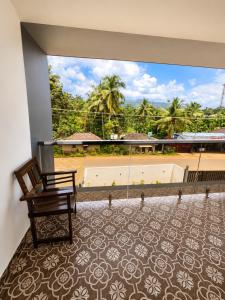a room with a chair and a large window at Pinto Eden Home Stay 5 Star Luxury Stay in Chikmagalur in Sangameswarpet