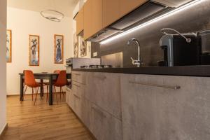 a kitchen with a table with orange chairs in it at La Casa al Centro in Policoro