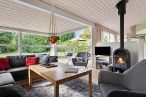 a living room with a couch and a fireplace at 1627-Dronningmolle-Svalevej-3 in Dronningmølle