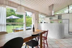 a kitchen and dining room with a table and chairs at 1627-Dronningmolle-Svalevej-3 in Dronningmølle