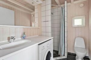 a bathroom with a sink and a washing machine at 1627-Dronningmolle-Svalevej-3 in Dronningmølle +14 photos