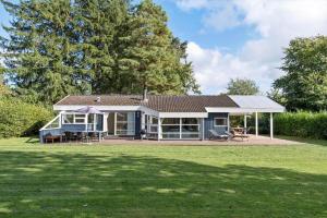 a small blue house with a large yard at 1627-Dronningmolle-Svalevej-3 in Dronningmølle