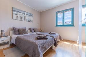 a bedroom with two beds and a couch at Gina Gedici Resort in Gedići +12 photos