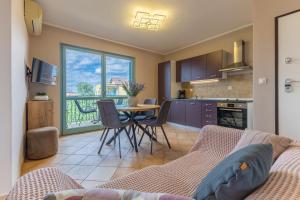 a living room with a couch and a table with chairs at Gina Gedici Resort in Gedići