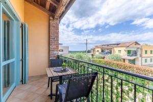 a patio with a table and chairs on a balcony at Gina Gedici Resort in Gedići