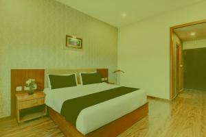 a bedroom with a large bed in a room at Prabin Ghatiya Homeinn in Patna +3 photos
