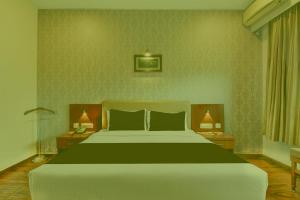 a bedroom with a large bed with green walls at Prabin Ghatiya Homeinn in Patna