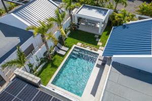 an overhead view of a swimming pool next to a house at Villa Solis - Elegant & Modern Private Pool Escape in Cap Malheureux +30 photos