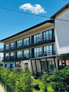 a building with balconies on the side of it at pensiunea delta ideal in Sulina