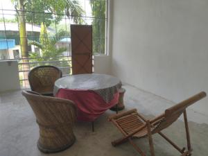 a table and chairs in a room with a window at Natraj hotel rooms and restaurant in Motīnāla