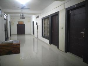 an empty hallway with two doors and a ceiling at Natraj hotel rooms and restaurant in Motīnāla