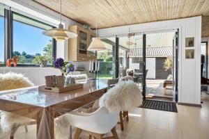 a living room with a dining table and chairs at 30154-Odder-Pouli-Nielsensvej-99 in Odder