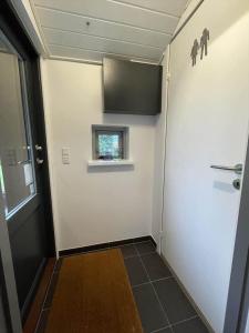 a hallway with a door and a window in a room at 30154-Odder-Pouli-Nielsensvej-99 in Odder