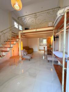 a room with a loft bed and a living room at Thea Suite & Loft in Kavála