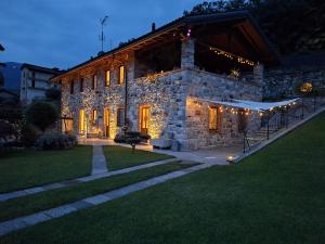 a stone building with lights on it at night at Residenza Jasmine in Verbania