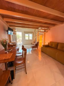 a living room with a couch and a table at Thea Suite & Loft in Kavála