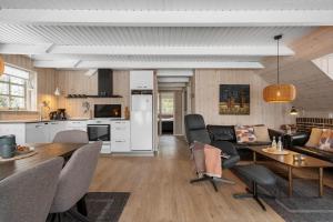 a kitchen and living room with a couch and a table at 146-Ringkobing-Hvidbjergvej-23 in Søndervig