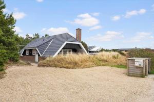 a house with a solar roof on top of it at 146-Ringkobing-Hvidbjergvej-23 in Søndervig