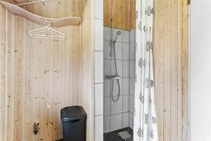 a shower in a bathroom with a wooden wall at LF403-Hurup-Thy-Klydevej-6 in Sindrup +15 photos