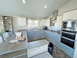a kitchen with white cabinets and a counter top at The Retreat 22 - Ukc9564 in Ingoldmells
