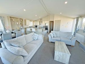 a living room with two couches and a table at The Retreat 22 - Ukc9564 in Ingoldmells