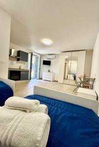 a living room with a blue couch and a kitchen at PAMA Home in Acerra