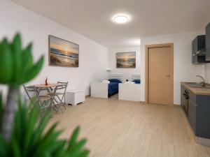 a living room with a table and a bedroom at PAMA Home in Acerra +30 photos