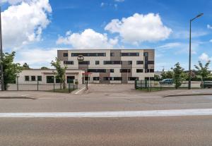an empty parking lot in front of a building at B&B HOTEL Colmar Expo in Colmar