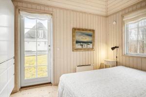 a bedroom with a bed and a large window at 1523-Vejby-Store-Orebjergvej-53-B in Vejby