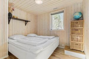a bedroom with a bed in a room with a window at 8302-Kolind-Falkevej-34 in Kolind