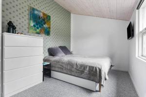 a small bedroom with a bed and a dresser at LF15081-Farso-Illeris-121 in Farsø